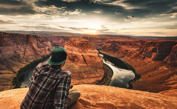 istock man resting at horseshoe bend in usa 1153445285
