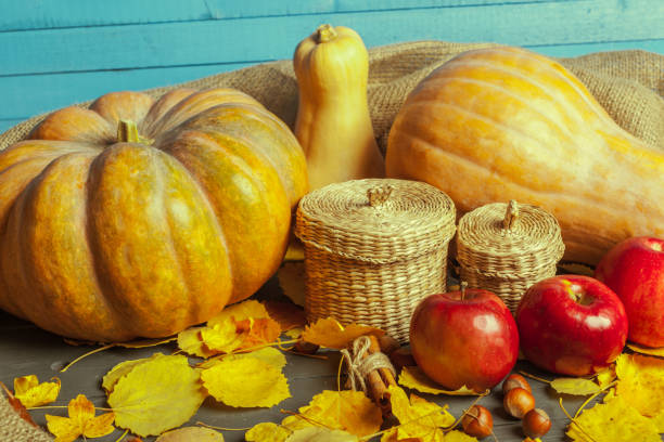 istock pumpkins on wooden board 1153445287