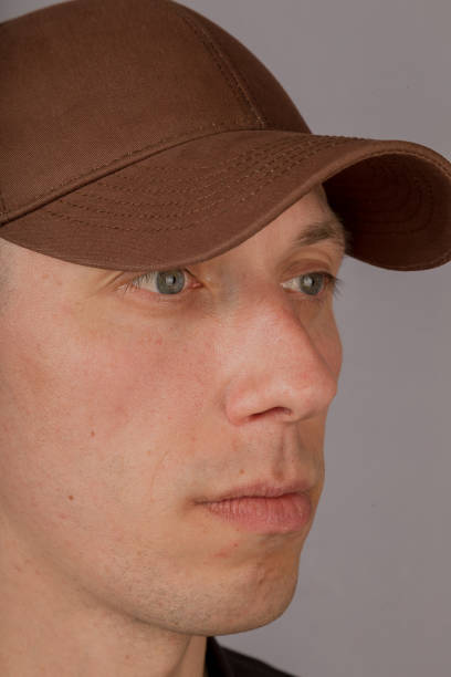 istock Handsome young man in a headdress on a gray background 1153445456