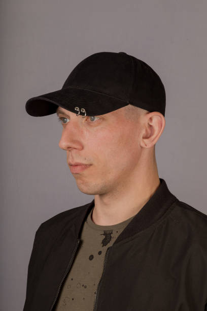 istock Handsome young man in a headdress on a gray background 1153445532