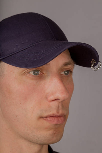 istock Handsome young man in a headdress on a gray background 1153445738
