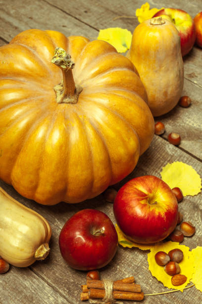 istock pumpkins on wooden board 1153445783