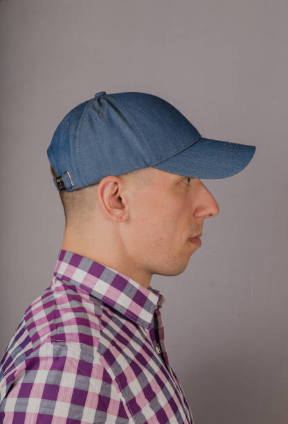 istock Handsome young man in a headdress on a gray background 1153446116