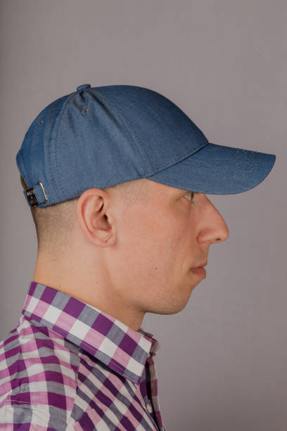 istock Handsome young man in a headdress on a gray background 1153446128