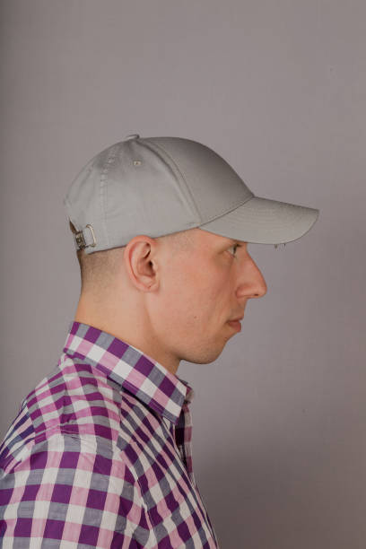 istock Handsome young man in a headdress on a gray background 1153447133