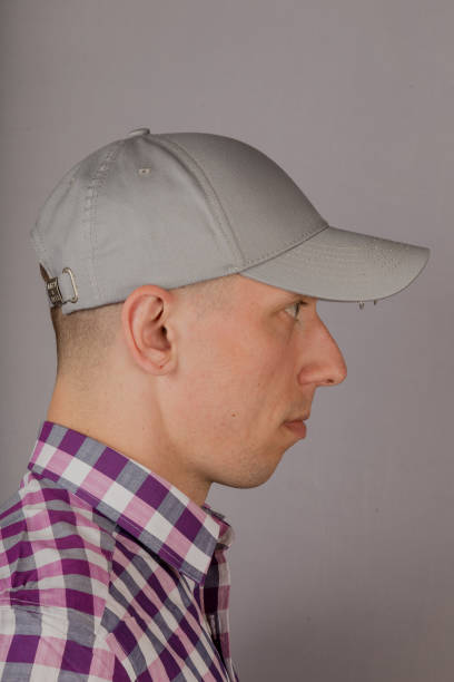istock Handsome young man in a headdress on a gray background 1153447147