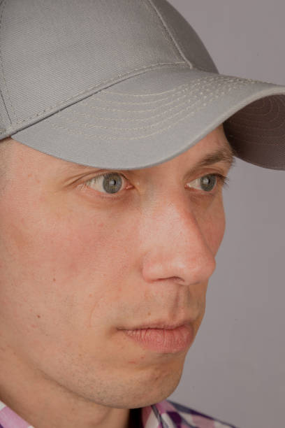 istock Handsome young man in a headdress on a gray background 1153447162