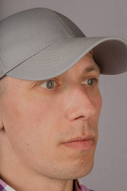 istock Handsome young man in a headdress on a gray background 1153447510