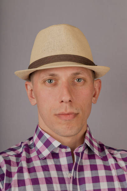 istock Handsome young man in a headdress on a gray background 1153448289