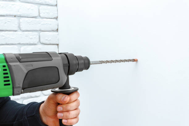 istock Use hammer drill to drill the wall 1153448386