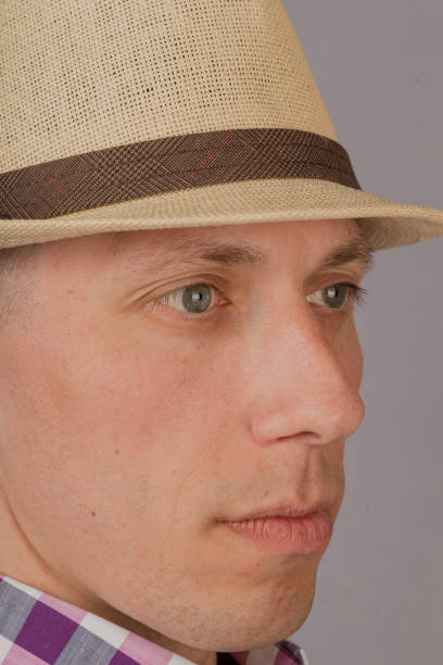 istock Handsome young man in a headdress on a gray background 1153448387