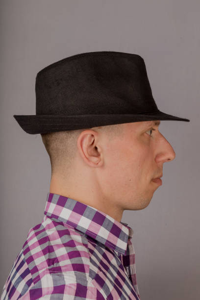 istock Handsome young man in a headdress on a gray background 1153448497