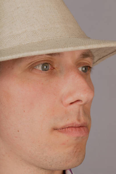 istock Handsome young man in a headdress on a gray background 1153448656