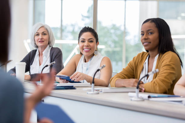Diverse panel of women answer questions during expo When an unrecognizable person in the audience asks a question, the diverse panel of women is ready to answer. control panel stock pictures, royalty-free photos & images