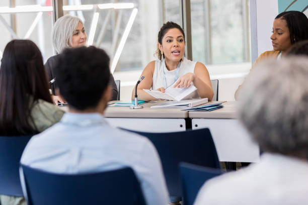 istock Mid adult Hispanic woman explains that day's expo schedule 1153450879