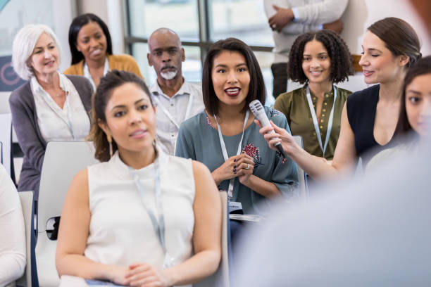 istock During Q and A after expo attractive woman asks question 1153450881