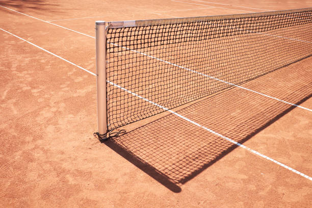 istock red sand tennis field with net background 1153450923