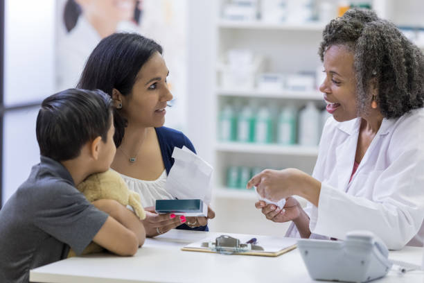 istock Pharmacist discusses drug side effects with customers 1153450963