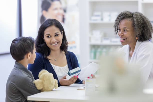 istock Cheerful woman receives medication for son 1153450970
