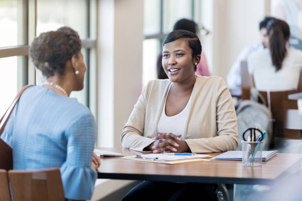 istock Mid adult bank employee talking with client 1153450988