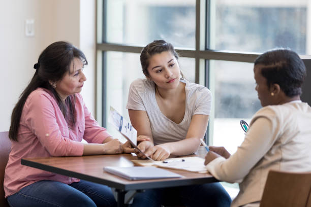 istock Young woman asks bank employee a question about a loan 1153451037