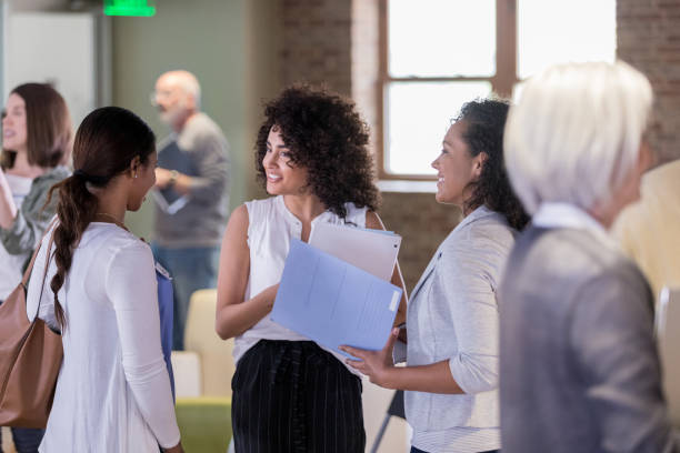 istock Female homeowners talk together at a community event 1153451064