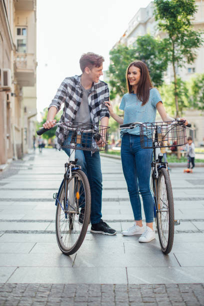 istock Young couple walking by their bicycles 1153451697