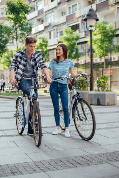 istock Couple walking by their bicycles and smiling 1153451842