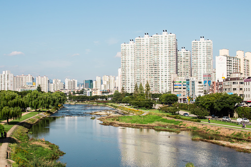 Daegu, South Korea - September 22, 2018 :
View of downtown cityscape and Sincheon river (stream), Daegu, Korea. Daegu is large manufacturing industry city in Korea. Many companies such as Daegu Bank, Korea Delphi, Hwasung corp., and TaeguTec are situated in this city and Samsung and Kolon were founded in this city.