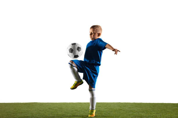 istock Young boy as a soccer or football player on white studio background 1153452125