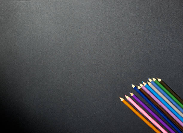 istock Minimal back to school background Colorful pencils on a blackboard 1153453621