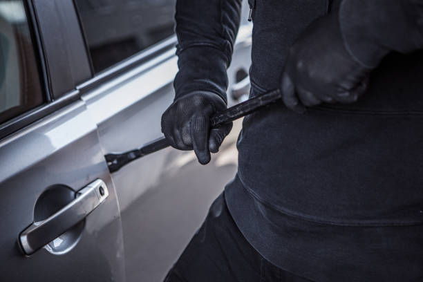 Unknown Criminal stealing a car stock photo