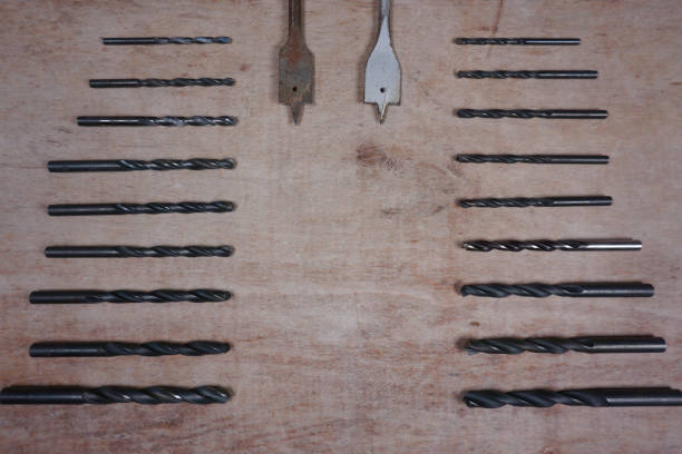 istock Cordless drill, screwdriver with drill bit on wooden background with copy space for your own text 1153454709