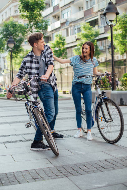 istock Couple walking by their bicycles and having fun 1153455798