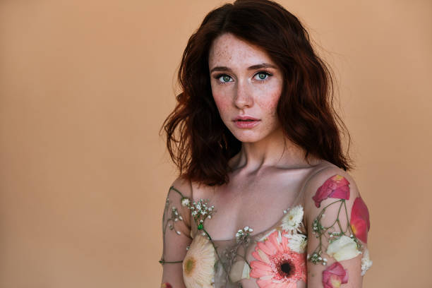 Portrait a summer girl with flowers in studio