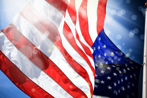 istock close up waving American flag and light beam with abstract lights 1153458654