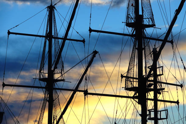istock sailing boats silhouetted by sunset light in harbor 1153458896