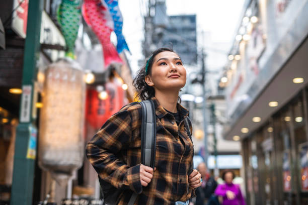 istock Young Mongolian Female Traveler Exploring Tokyo at Dusk 1153460361