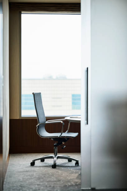 istock Empty office chair by window in hotel 1153461323