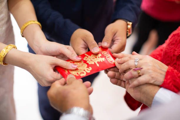 istock Elders giving red packet to newlywed couple 1153461456