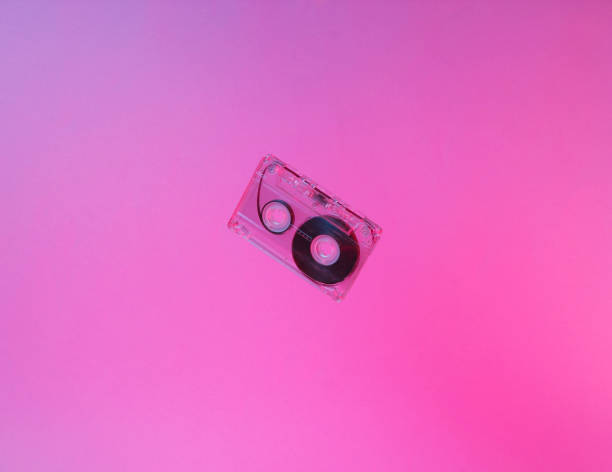 istock Minimalism retro style concept. 80s. Audio cassette in neon red blue light. Retro wave 1153461643