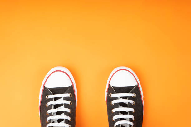 istock shoes with white rubber tip on yellow background 1153461644