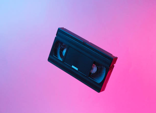 istock Minimalism retro style concept. 80s. Video cassette in neon red blue light. Retro wave 1153461667
