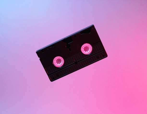 istock Minimalism retro style concept. 80s. Video cassette in neon red blue light. Retro wave 1153461779