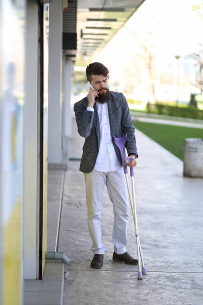 istock Young beautiful bearded man with walking sticks on the stree 1153462902