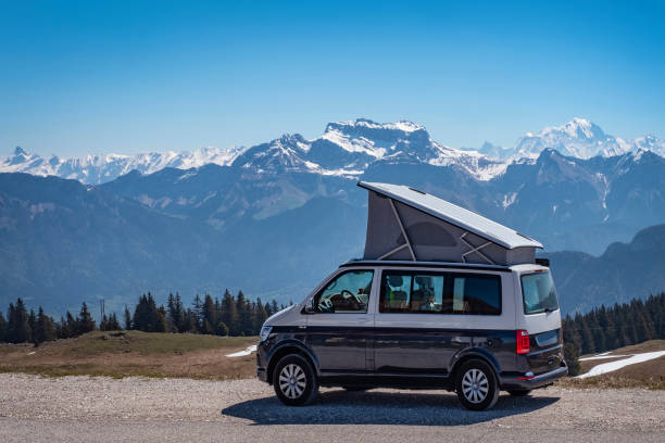 Popup Campervan Popup Campervan, Jura, French Alps - May 10, 2019: camping with small lifting roof van in snow covered mountains of France. jura france photos stock pictures, royalty-free photos & images