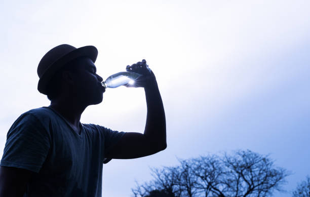 istock Young handsome asian man drinking water 1153463604