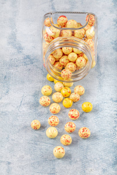 istock Colored chocolate coated hazelnut dragee in sugar bowl . Handmade colorful chocolate candies filled with nuts. 1153464385