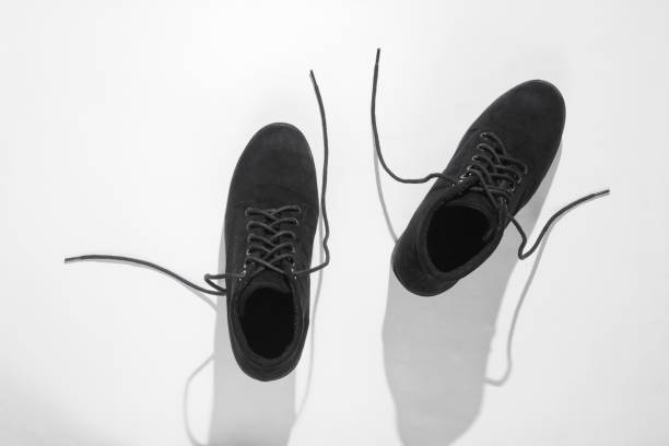 istock Black suede boots with laces on a white background. Top view 1153464949