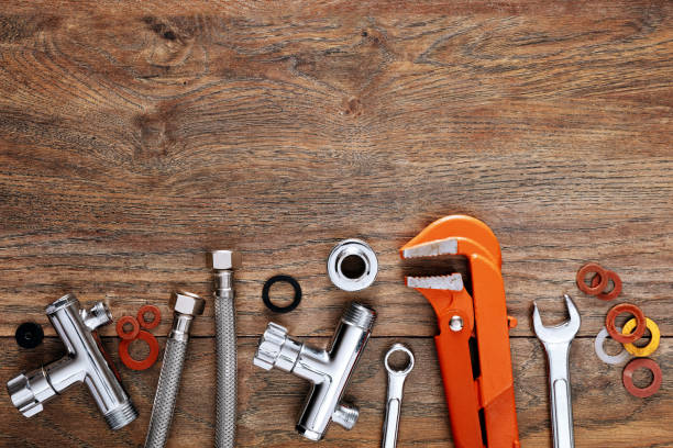 Set of plumbing tools on wooden table background. Set of plumbing tools on wooden table background. Close up top down view with copy space. Plumber stock pictures, royalty-free photos & images